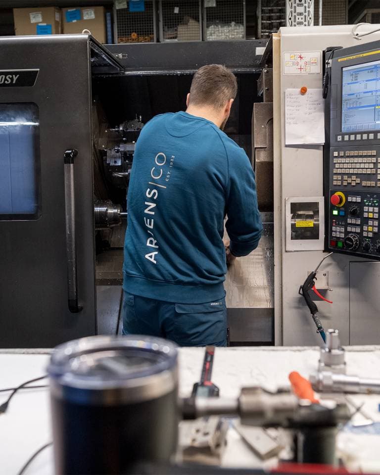 Factory worker of AriensCo EMEAA wearing their new turquise work wear inside their factory in Bühlertann, Germany