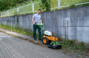 AS 60 E-WeedHex AP in action, brushing/removing weed on cobblestone